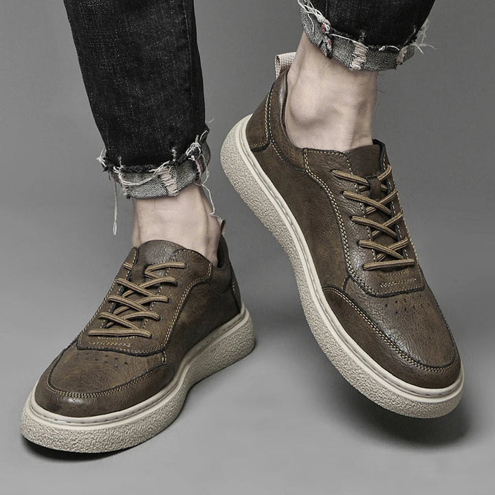 Durable rubber sole of men's genuine leather perforated sneakers, designed for everyday comfort and traction.