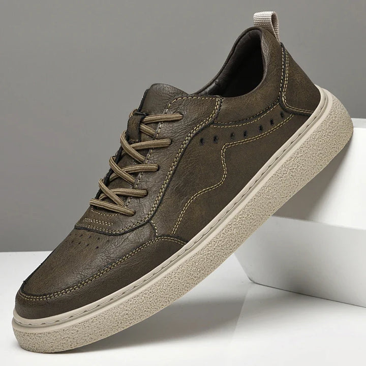 Minimalist design men's genuine leather perforated sneakers, offering a clean, stylish look for casual outfits.