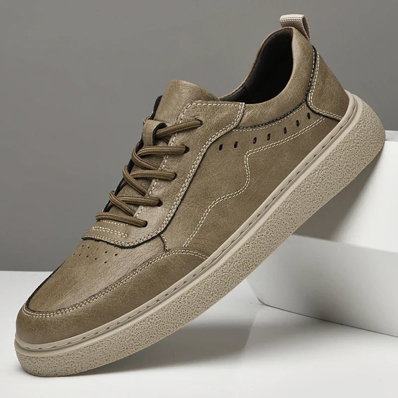 High-quality men's genuine leather sneakers featuring breathable perforations and a classic low-top profile.