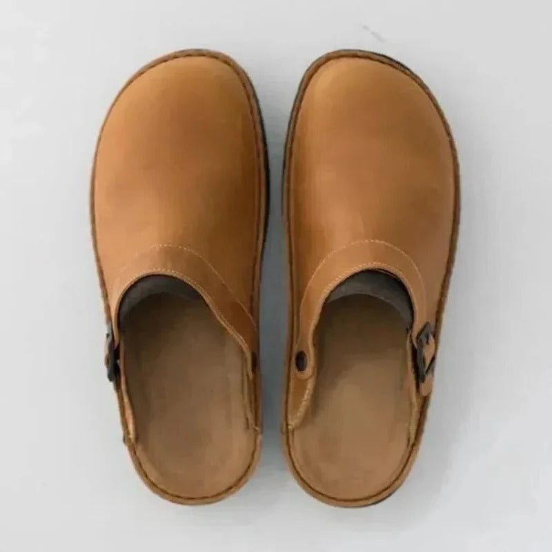 Comfortable men's leather slippers with removable orthotic insoles for superior foot support.
