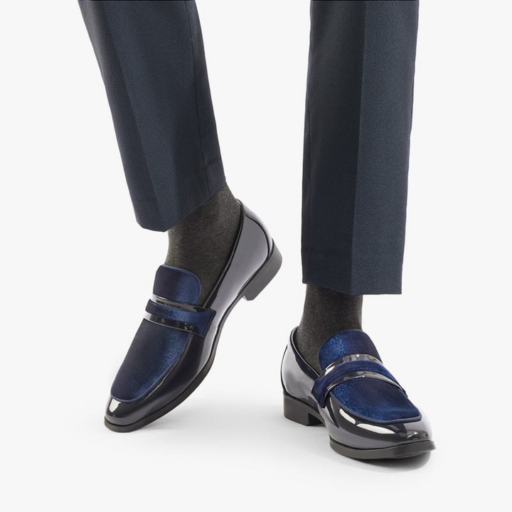 Stylish men's glossy navy dress loafers worn, perfect modern formal footwear for elegance & comfort.