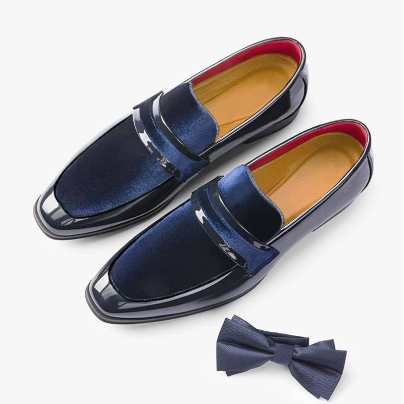 Men's glossy black dress loafers paired with a suit, ultimate modern formal occasion wear.