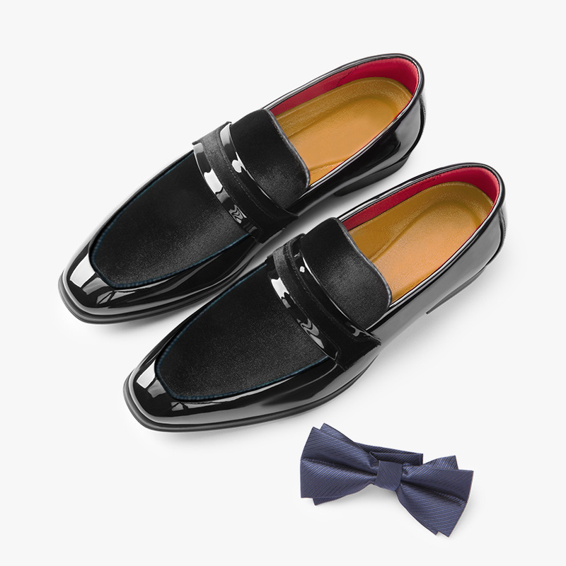 Side profile of elegant men's glossy navy loafers, sophisticated modern formal slip-on shoes.