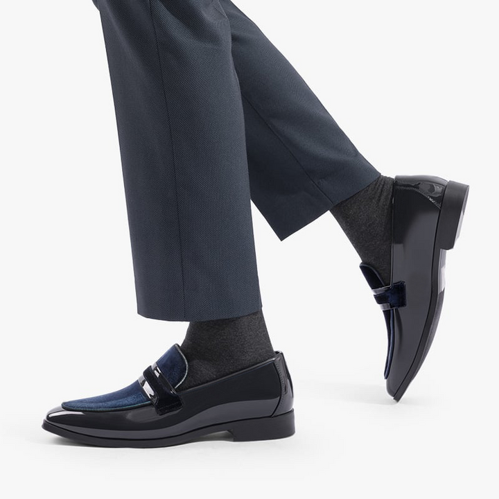 Man wearing glossy black formal loafers, modern elegant dress shoes for parties & special events.