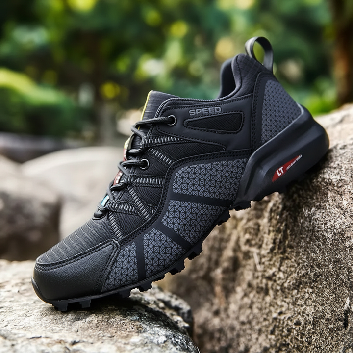 Men's Grant waterproof hiking boots, ideal for outdoor adventures, on a rocky path