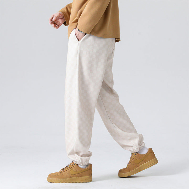 Cream & black checkerboard men's sweatpants for streetwear, offering a stylish & comfortable fit.