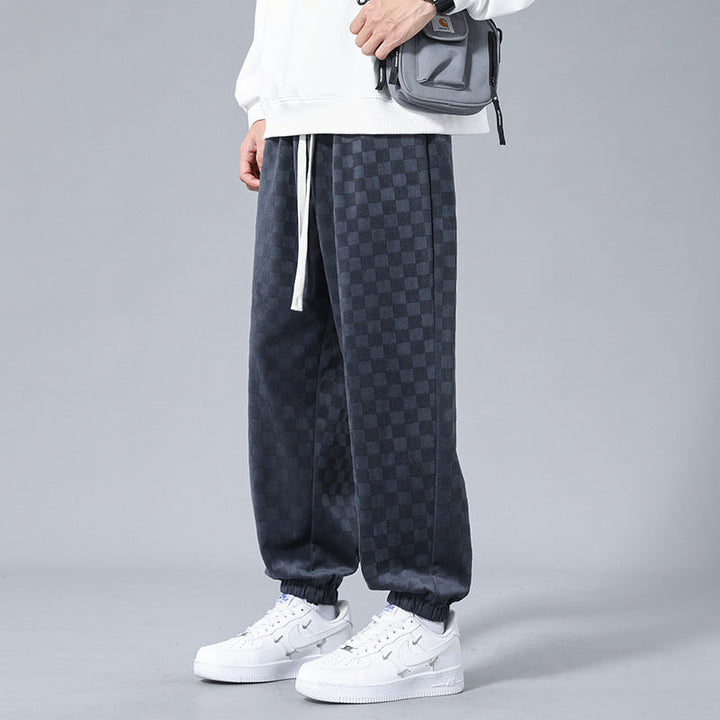 Comfortable men's checkerboard sweatpants, black & cream, perfect for stylish streetwear or lounging.