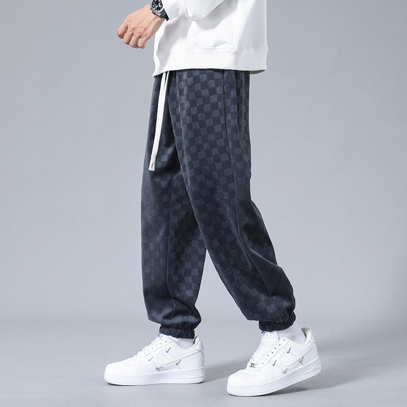 Stylish men's checkerboard wide-leg sweatpants in gray & black, offering a relaxed fit for fashion.