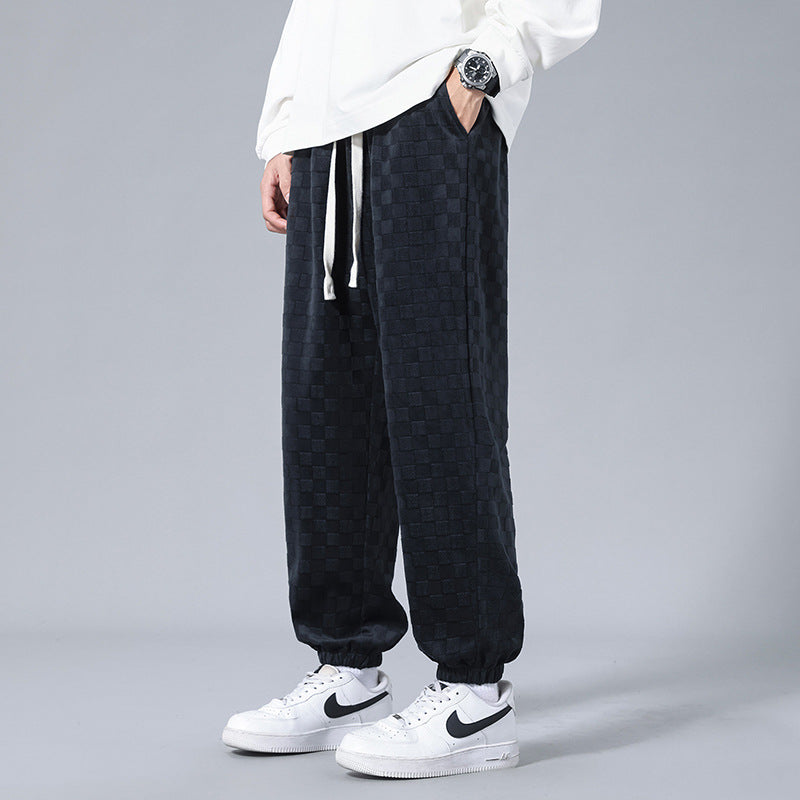 Elevated black & cream checkerboard men's sweatpants, a key piece for modern streetwear fashion.