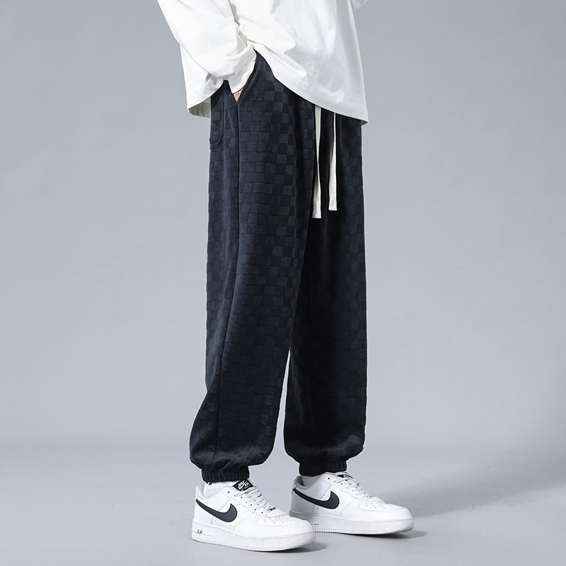 Gray and black checkerboard pattern men's sweatpants, casual and stylish, designed for comfort.