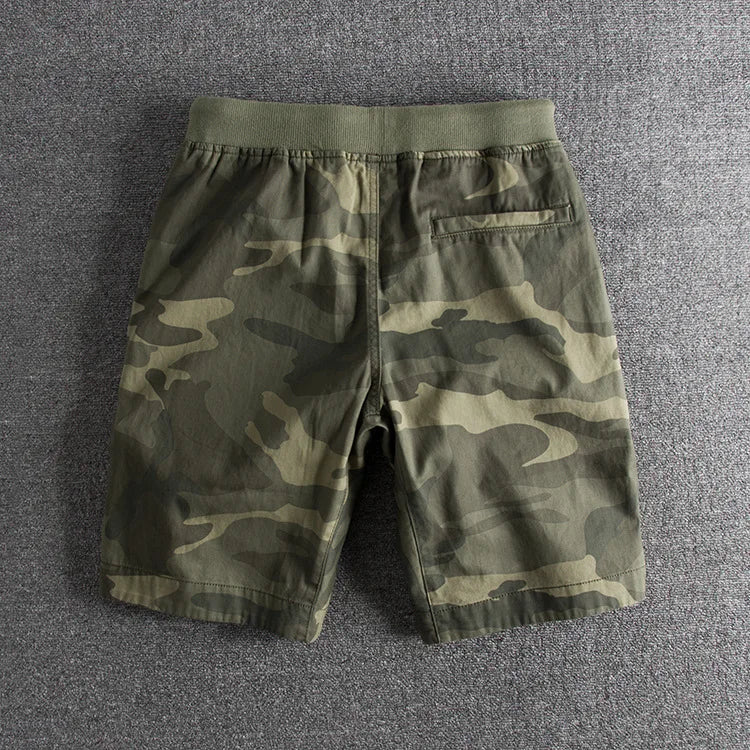 Stylish men's green camo shorts for active casual wear. Comfortable summer military shorts, great for outdoor fashion.