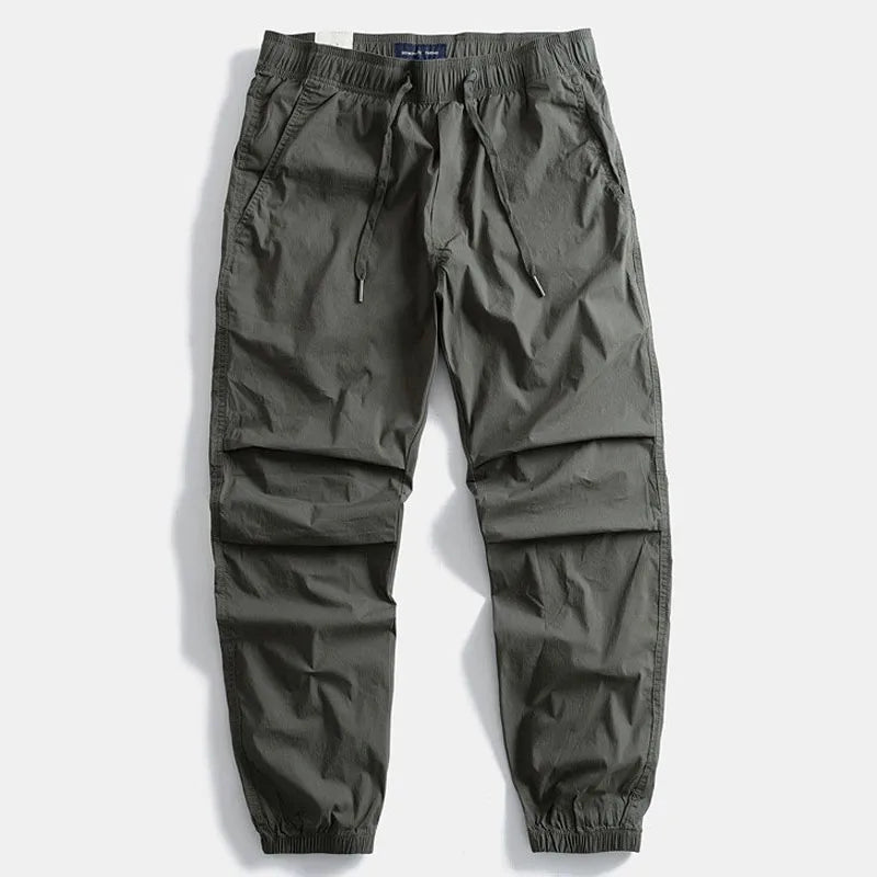 Men's gray cargo pants, comfortable & versatile for everyday wear, travel, or outdoor activities.