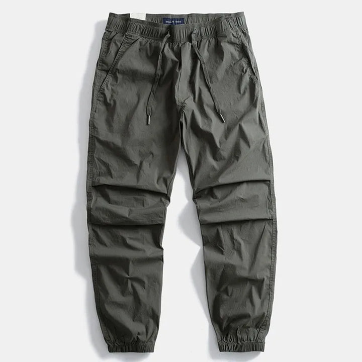 Men's gray cargo pants, comfortable & versatile for everyday wear, travel, or outdoor activities.
