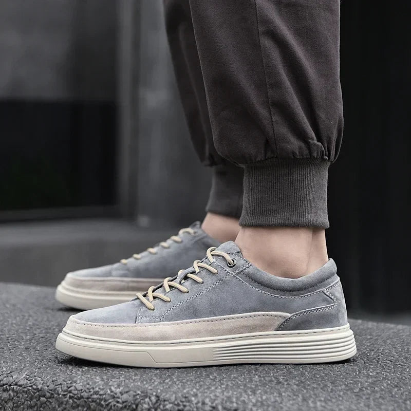 Close-up of premium men's suede casual sneakers, highlighting soft texture & durable leather.