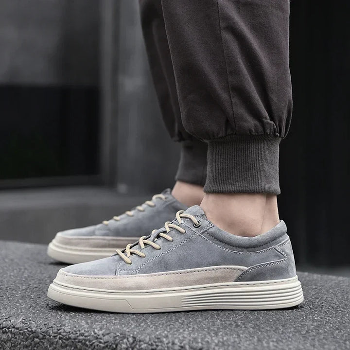 Close-up of premium men's suede casual sneakers, highlighting soft texture & durable leather.