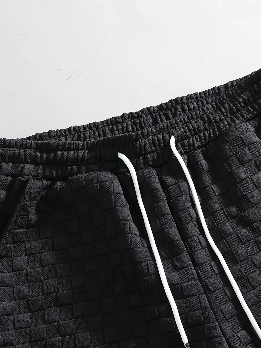 Modern men's two-piece checkered lounge set. Comfortable shorts and top for stylish casual or home wear.