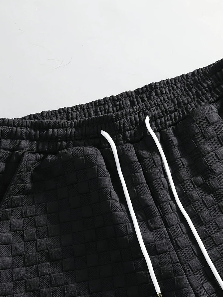 Modern men's two-piece checkered lounge set. Comfortable shorts and top for stylish casual or home wear.