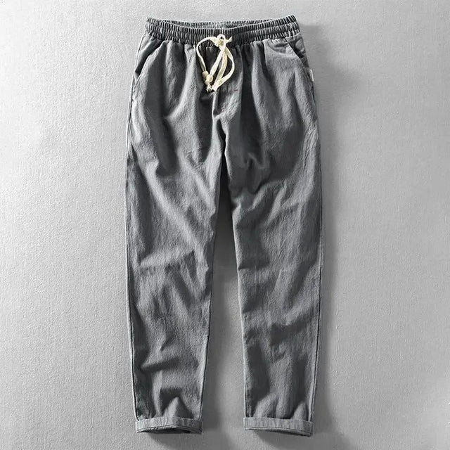 Breathable men's linen pants, comfortable & casual summer wear with tapered leg and drawstring.