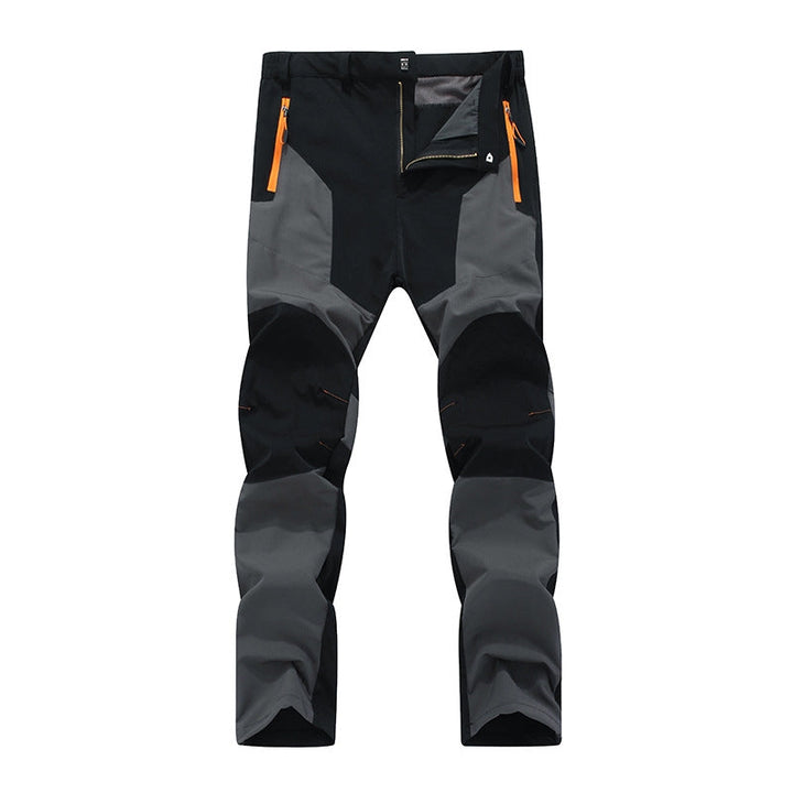 Durable men's waterproof work pants with reinforced knees & comfort fit for heavy-duty outdoor utility tasks.