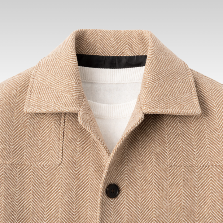 Man wearing a stylish herringbone knit jacket, ideal for a warm fall or winter look.
