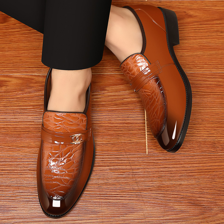 Elegant men's high-shine slip-on loafers with textured vamp, sophisticated formal dress shoes.