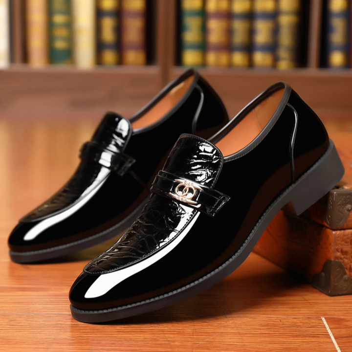Men's slip-on loafers with textured vamp & elegant gold accent, perfect for dress occasions.