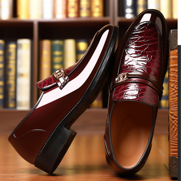 Men's high-shine slip-on loafers with textured vamp, gold accent, for a sophisticated classic style.