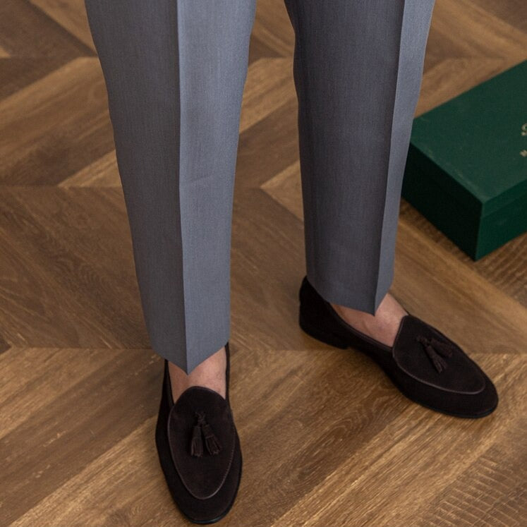 Man wearing sophisticated men's high-waist Gurkha trousers with a crisp shirt.