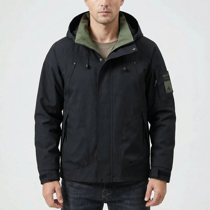 Man wearing lightweight hooded softshell windbreaker, perfect for active outdoor adventures & camping.