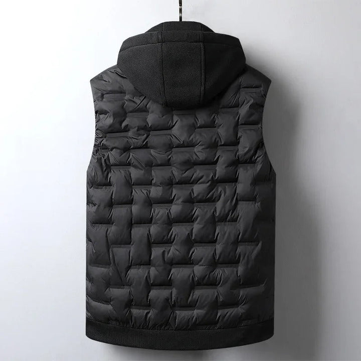 Front view of a rugged men's utility vest. Insulated for outdoor adventures, features a detachable hood.