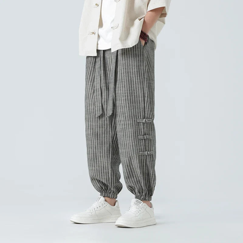 Men's Japanese streetwear pants with white side stripe. Comfort fit, loose style, perfect for urban casual fashion.