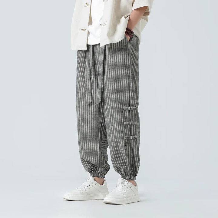 Men's Japanese streetwear pants with white side stripe. Comfort fit, loose style, perfect for urban casual fashion.