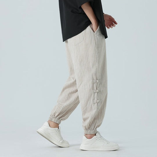 Versatile gray men's Japanese streetwear pants. Loose comfort fit with side stripe, ideal for urban style.