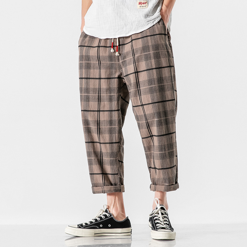 Comfortable men's Kaizen Grid tapered ankle pants, featuring a drawstring waist for a relaxed, modern fit.