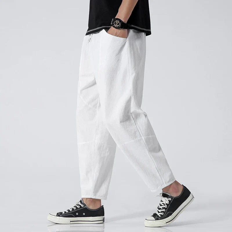Man wearing Katachi tapered cropped pants, showcasing comfortable modern fit & adjustable waist for casual wear.