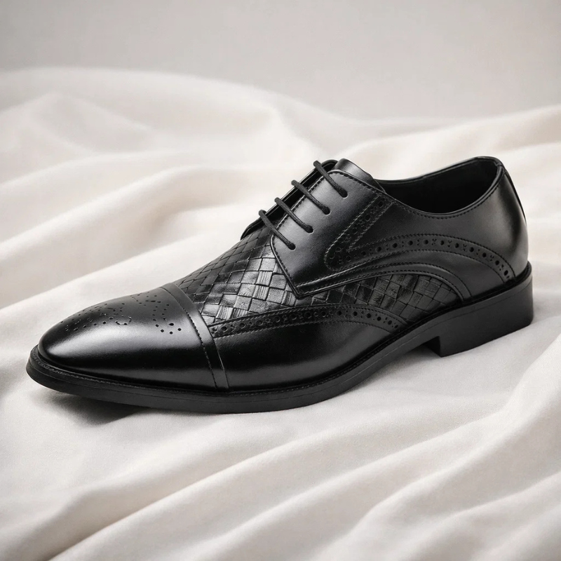 Intricate lace-up detailing on classic men's brogue oxford shoes, perfect formal footwear for refined taste.