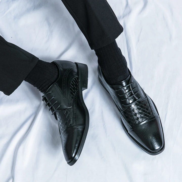 Close up of the premium leather texture on men's sophisticated Kensington brogue dress shoes.