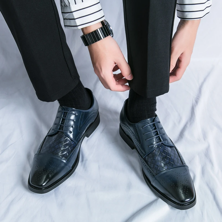 Side view of classic men's formal brogue shoes, ideal elegant footwear for business and dress occasions.