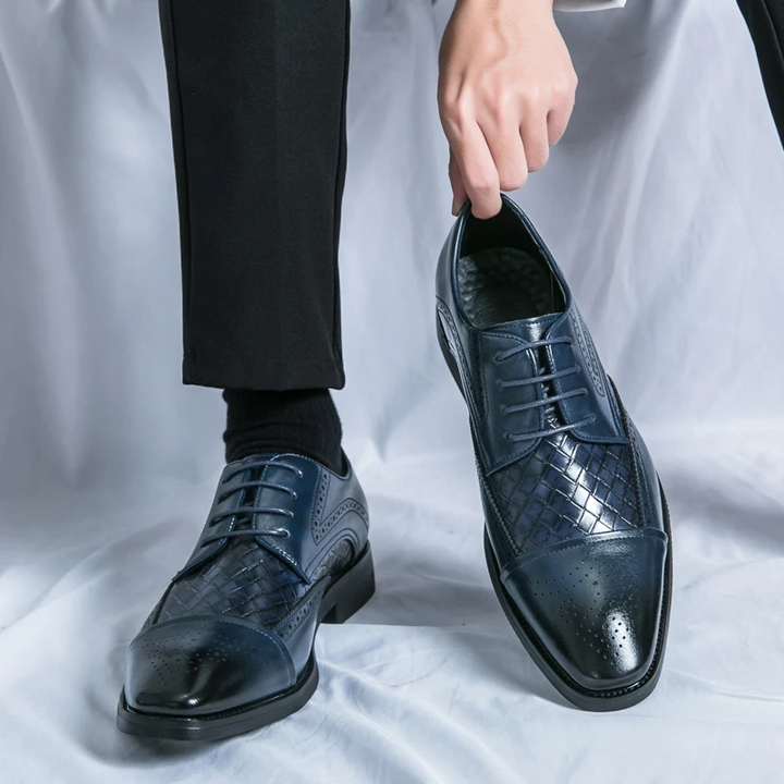 Pair of luxurious men's oxford brogue dress shoes, perfect for sophisticated business attire and formal events.