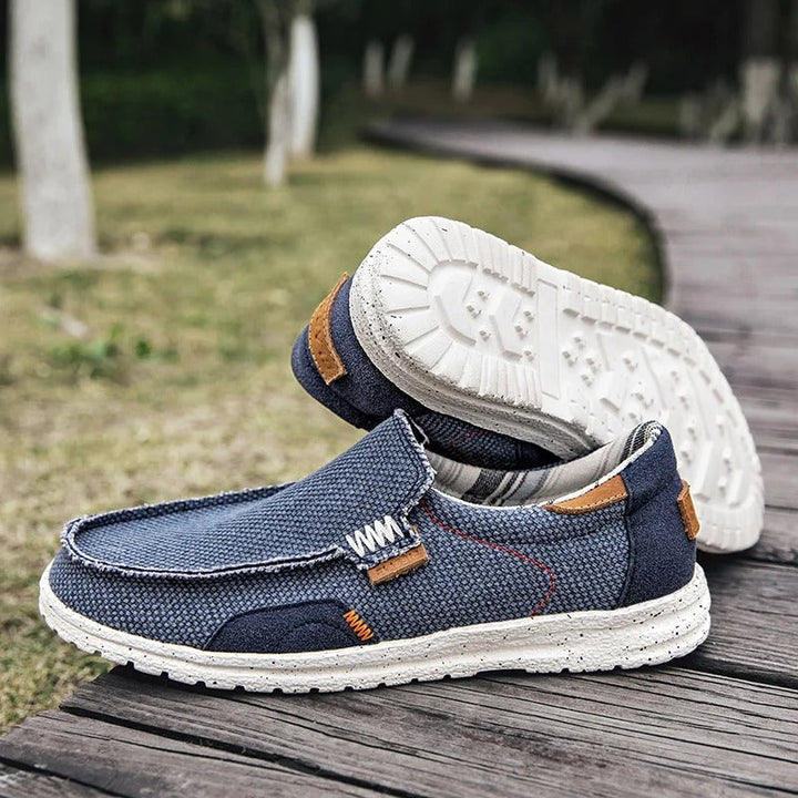 Top view: Men's gray canvas slip-on shoes, emphasizing easy wear & casual spring/summer comfort.