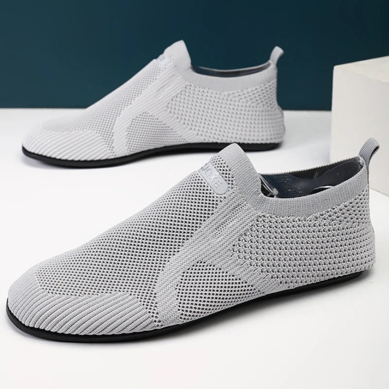 Men's khaki knit slip-on shoes. Breathable, lightweight, flexible design for barefoot comfort.