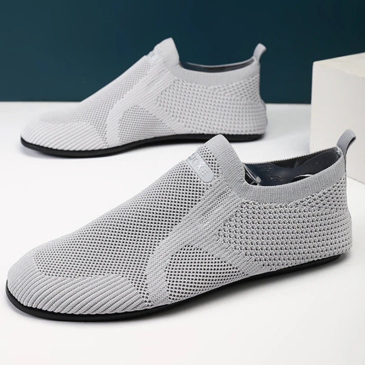 Men's khaki knit slip-on shoes. Breathable, lightweight, flexible design for barefoot comfort.