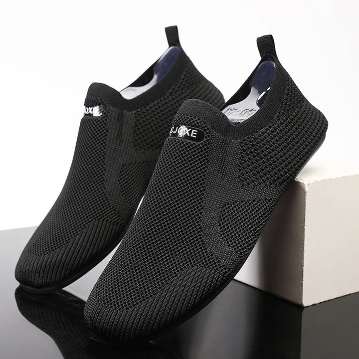 Black men's knit barefoot slip-on shoes. Flexible, laceless design for easy walking.