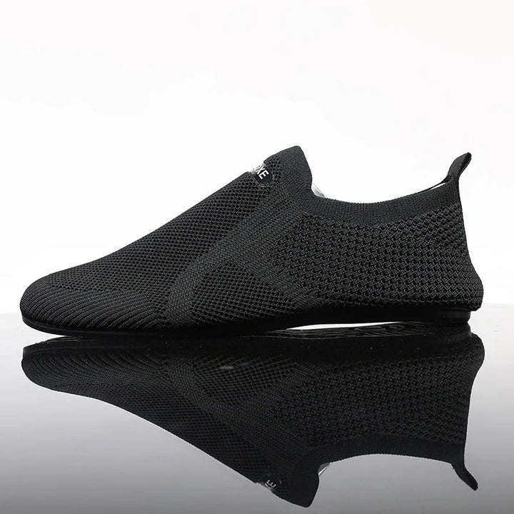 Pair of khaki men's knit barefoot slip-on shoes. Lightweight, flexible comfort for casual outings.