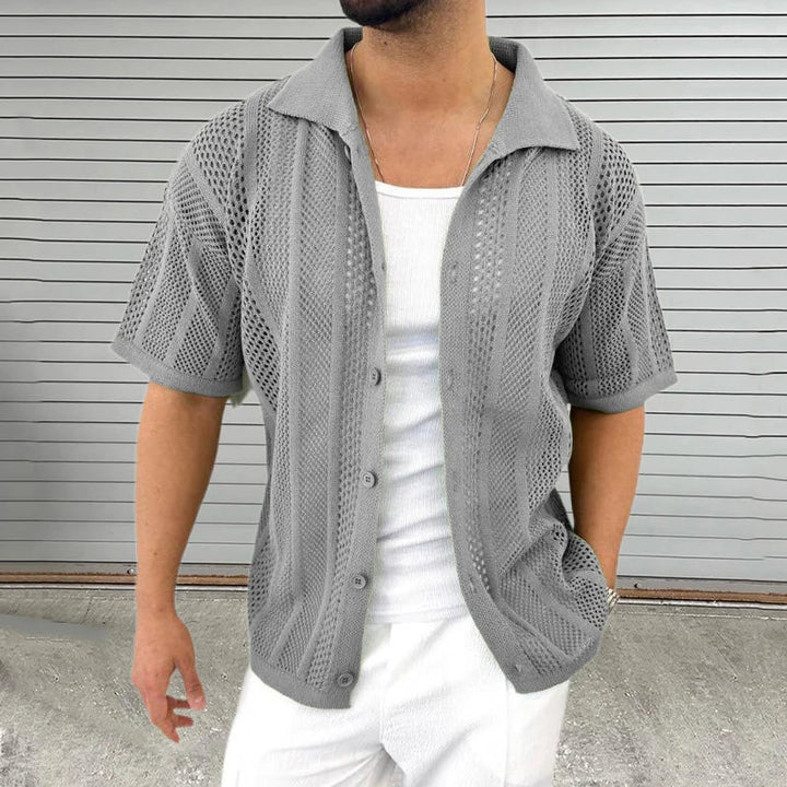 Stylish man wearing a blue knit short sleeve shirt with a classic collar for a relaxed summer look