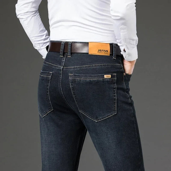Comfortable men's black stretch denim jeans, straight leg fit, ideal for travel and durable fashion.