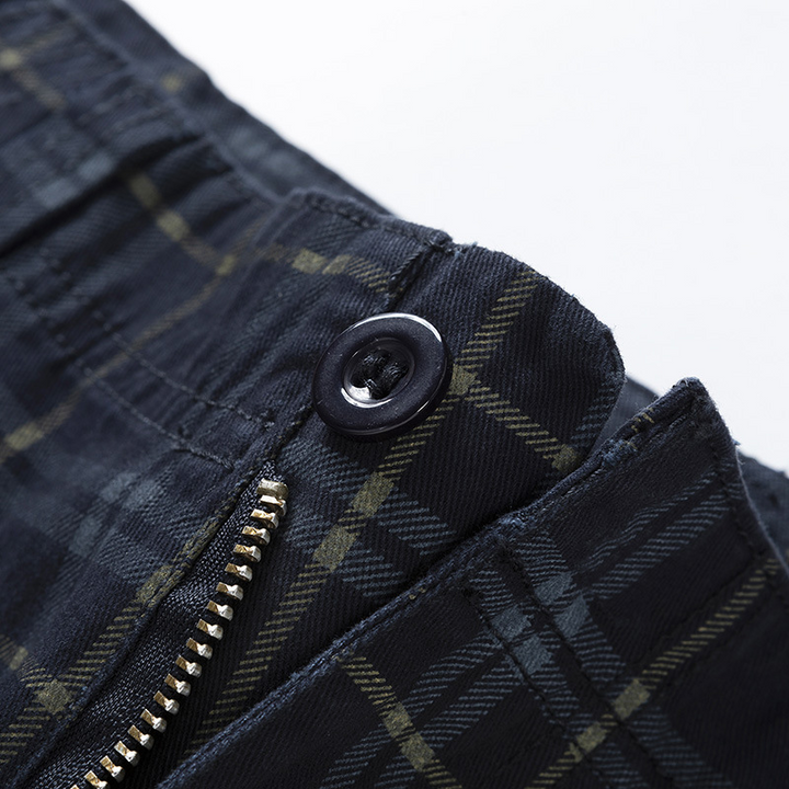 Close-up of lightweight fabric and check pattern on men's adventure cargo shorts, showing pocket detail.