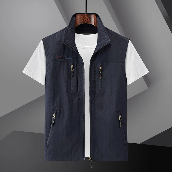 Men's lightweight adventure utility vest with multiple zip pockets, ideal for hiking & travel.