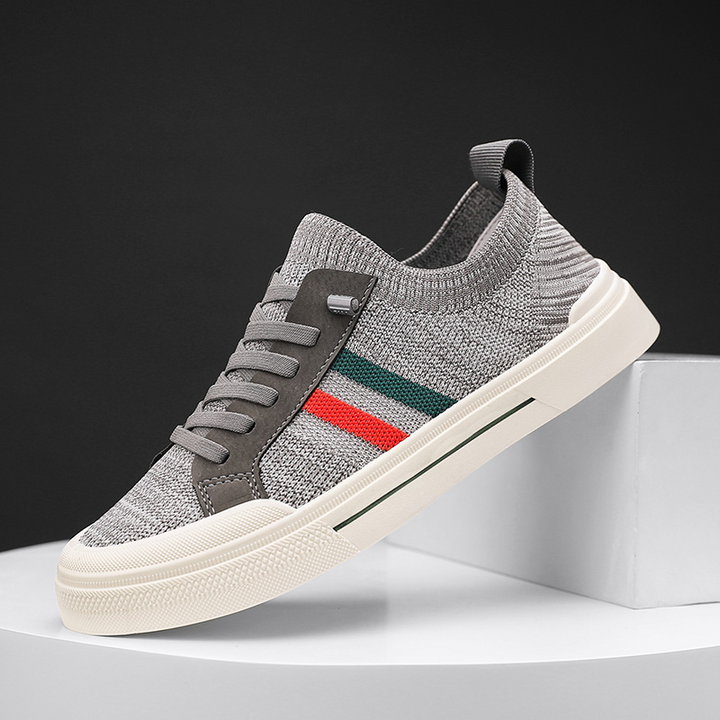Side profile of men's lightweight lace-up athletic sneakers, offering cushioned comfort for active men.
