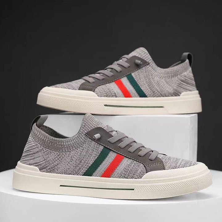 Front view of modern men's cushioned athletic sneakers, lightweight & breathable for versatile daily footwear.